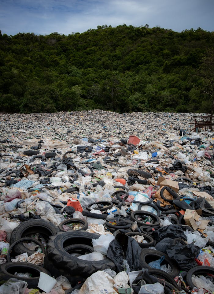 Expansive view of a landfill filled with tires and rubbish in Pattaya, Thailand.