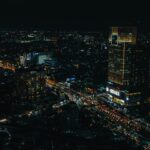 Stunning aerial view of Ho Chi Minh City with illuminated skyscrapers and bustling streets at night.